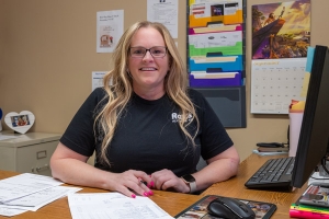 Ray's office worker happy at her desk.
