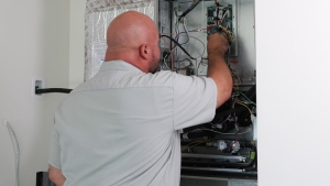 Ray’s HVAC tech providing heating services to a furnace